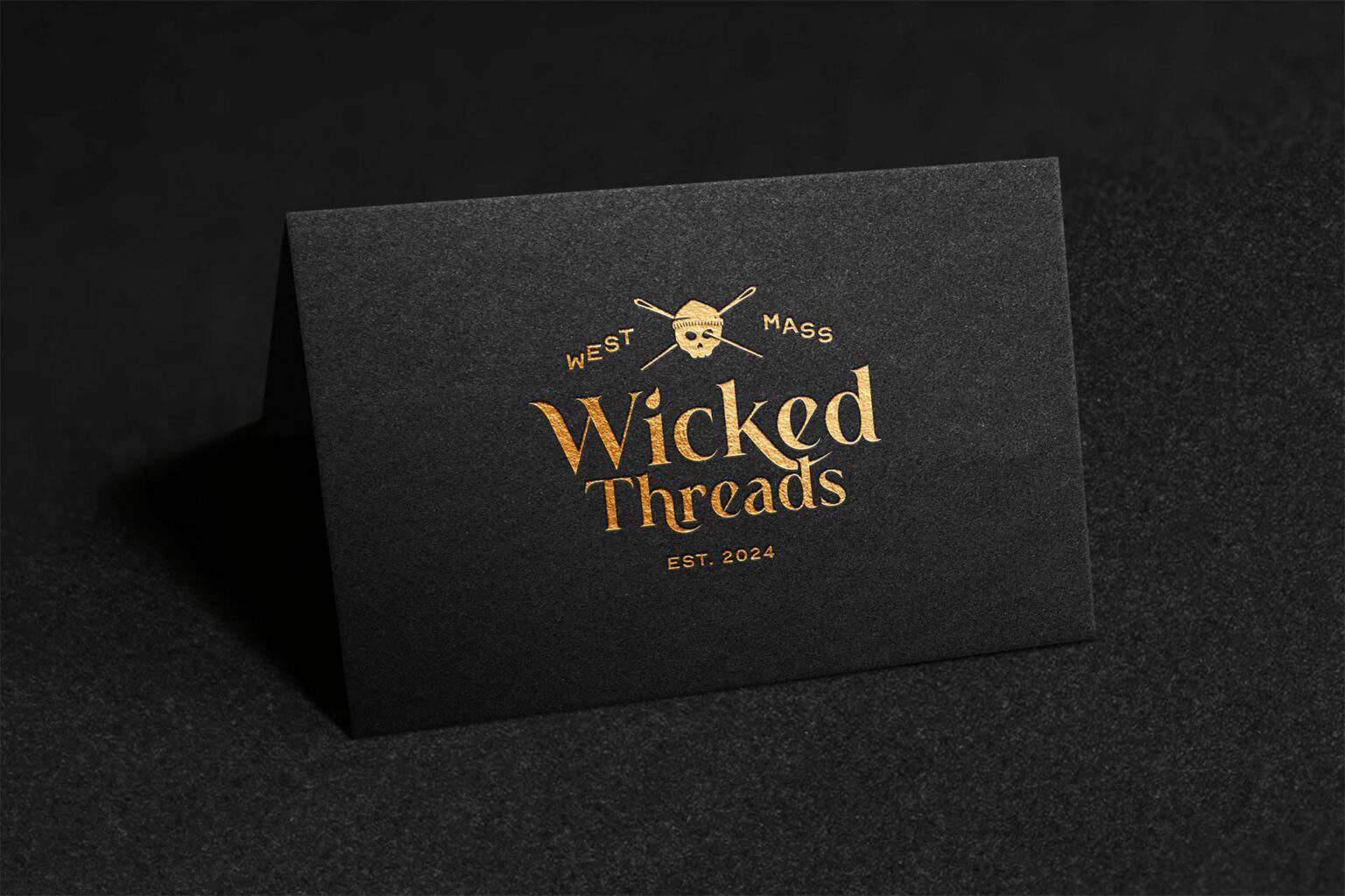Wicked Threads logo on a black business card